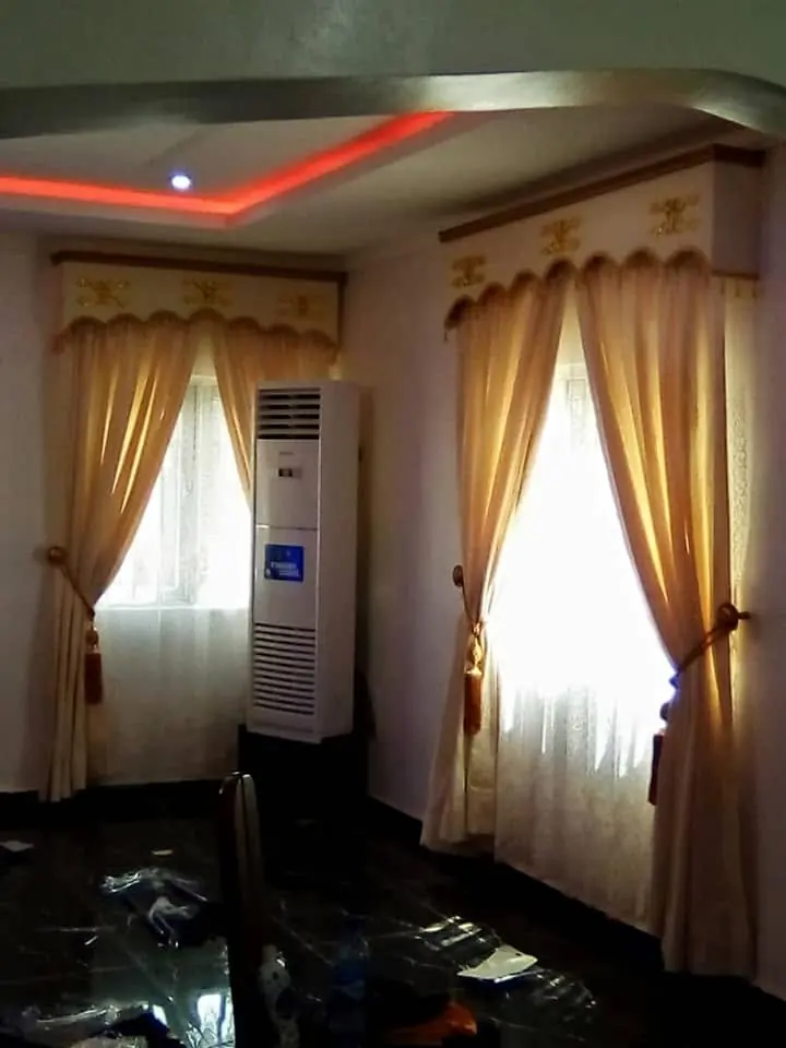 Gold curtains with valance in a hall