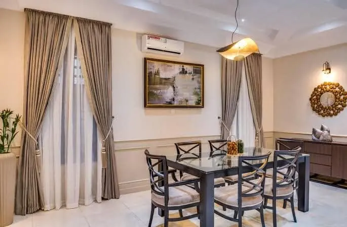 Dining room with tied-back curtains