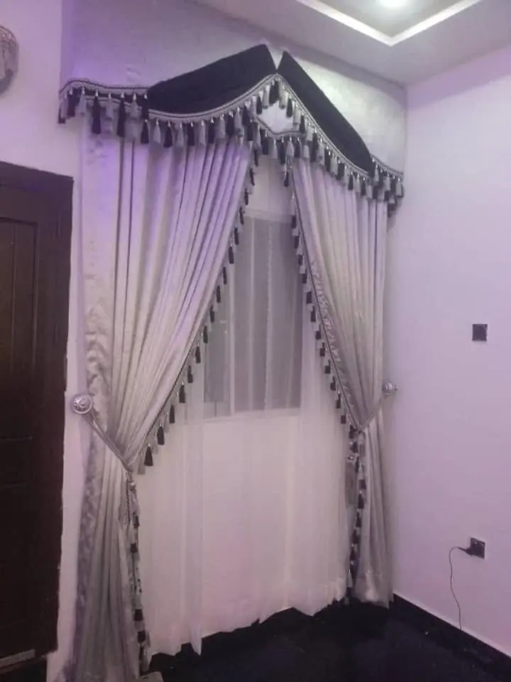 Black-trim curtain with swag in a hall