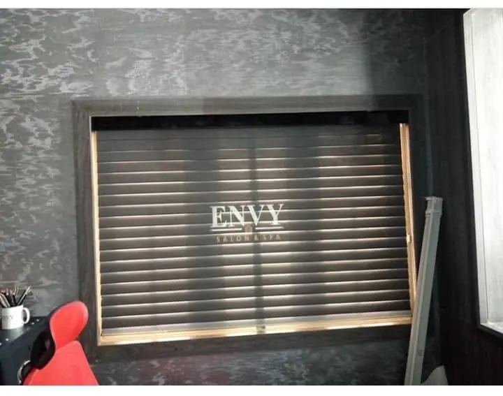 Brand name printed on a metallic slatted blind