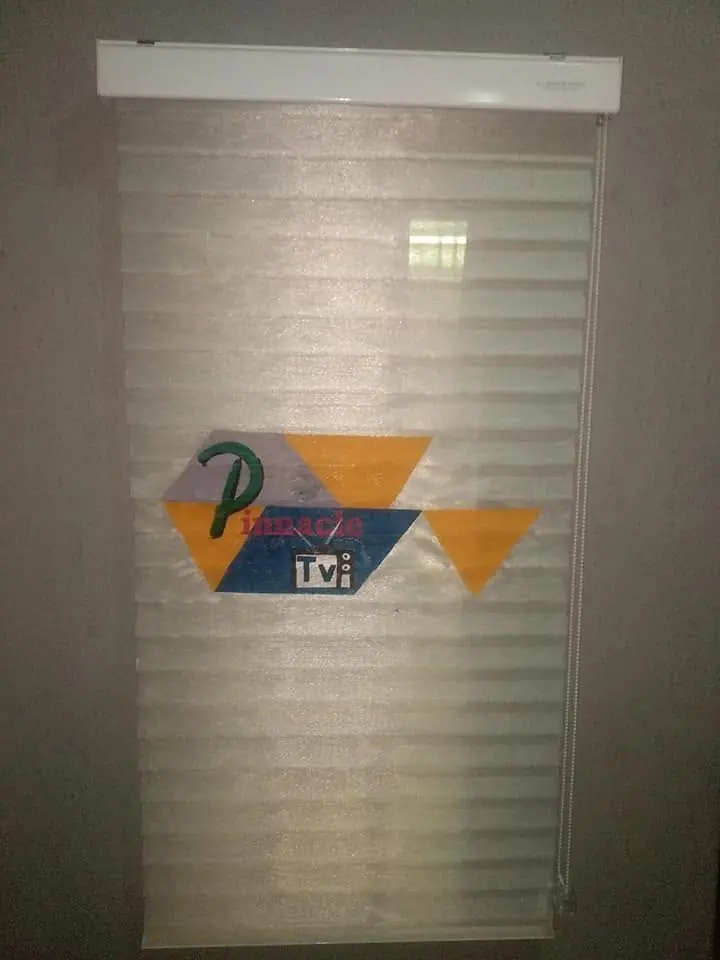 Television station logo on a zebra blind
