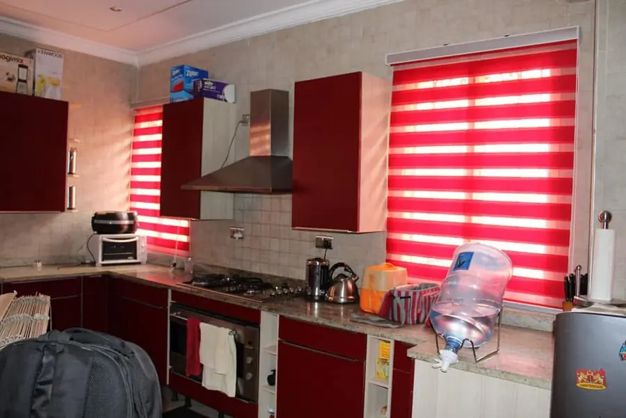 Red zebra blinds in a kitchen