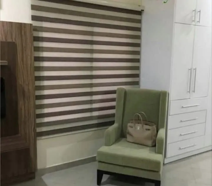Dual-shade blind in a bedroom corner
