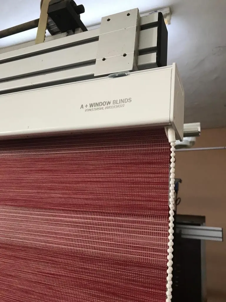 Red textured blind on a white headrail